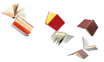 Old hardcover books flying on white background