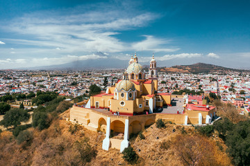 Fototapeta na wymiar View from the drone of the old Spanish church on the background of the city