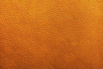 Texture of orange leather as background, closeup
