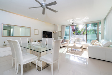 White furniture with sofa, dining table and ceiling fan in living room of villa, house, home, condo and apartment