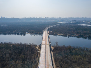 The construction of a bridge in Kiev across the Dnieper River. Aerial drone view.
