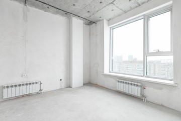interior of a new apartment without finishing in gray tones with electrical wiring