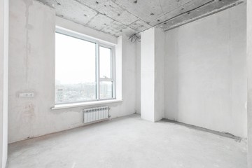 interior of a new apartment without finishing in gray tones with electrical wiring