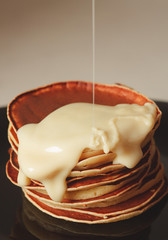 A Plate Of Pancakes with condensed milk
