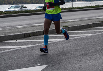 Fototapeta premium Detail view of athlete legs and feet, competing in a Marathon race. Sport, energy, close up