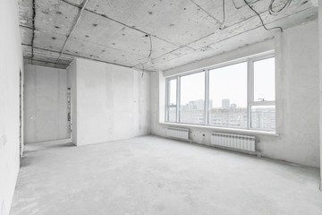 interior of a new apartment without finishing in gray tones with electrical wiring