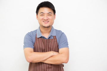 Fototapeta premium Portrait of Asian workers fresh market with brown apron standing with arms crossed isolated on white background