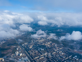 High flight in the clouds over the city of Kiev.