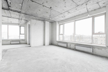 interior of a new apartment without finishing in gray tones with electrical wiring