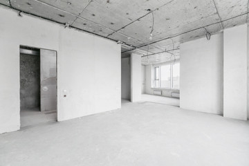 interior of a new apartment without finishing in gray tones with electrical wiring