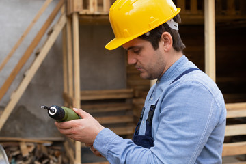 Carpenter holding electric drill