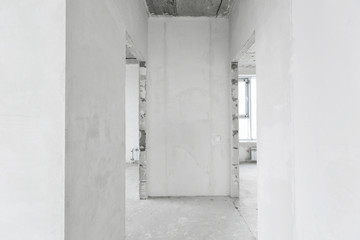 interior of a new apartment without finishing in gray tones with electrical wiring
