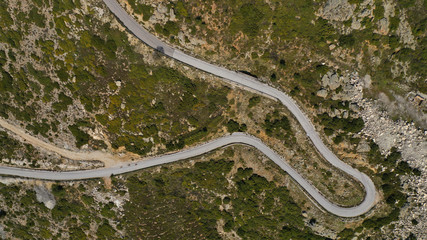 Aerial drone top down photo of snake winding mountain asphalt road as seen at spring
