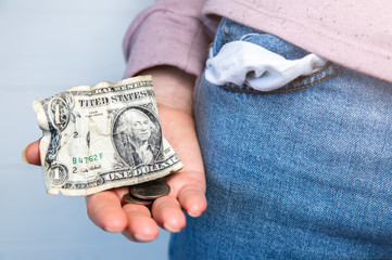 One dollar and petty cash only, empty pocket. No money. Economy crisis, poverty, unemployment concept. Consequences of coronavirus people isolation during quarantine. Inflation rates. Price growth. .
