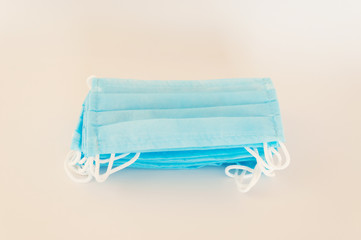 Fototapeta premium Protective medical masks are stacked on the table. Preparation for the departure for patients covid-19. Humanitarian Aid: A concept of protection during a coronavirus pandemic.