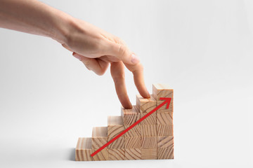 Career promotion concept. Woman and stairs built with wooden blocks on white background, closeup