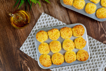 Baked brazilian cheese bread in baking pan with oil.