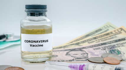 Covid19 vaccination and syringe injection with american money bills. Coronavirus