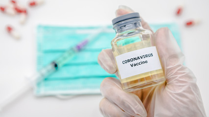 Scientist with vaccine of Covid19 in scientific chemical laboratory. Coronavirus
