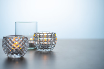 Lighted candles on table.
Quiet and chill lifestyle concept image.
