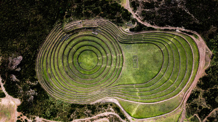 Aerial view of Moray Archeological site - Inca ruins of several terraced circular depressions, in Maras, Cusco province, Peru. Top tourist attraction in Sacred valley of the Incas.  - obrazy, fototapety, plakaty