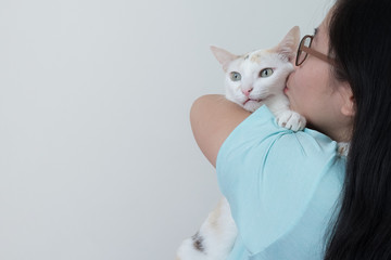Woman hugging and kissing her cat with love. This picture has space for putting description.