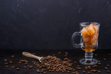 Frozen coffee ice cubes in a glass before pouring coffee