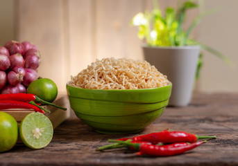 Noodle in a bowl with lime and chili and onion and vegetable
