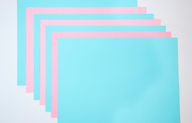 Sheets of paper in blue and pink. Geometric background image. Creative template for your text.