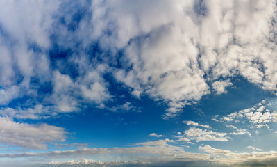 Naklejka na ściany i meble Fantastic clouds against blue sky, panorama