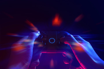 gamer boy with hand holding the joystick controller electronic for playing game with online network connection  technology device in esport tournament challenge concept © issaronow