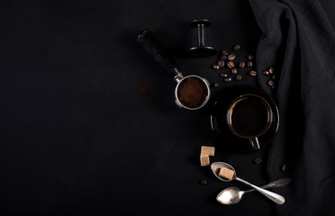 Coffee and utensils for coffee maker on black background with copy space for text