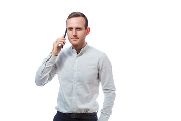 Caucasian man businessman, teacher mentor, talking on the phone and makes a selfie. He is wearing a shirt. Emotional portrait. Isolated on white background