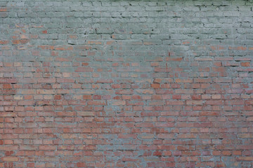 Old vintage dirty brick wall with peeling plaster. Background and texture