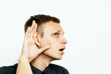 Overhears a man, tries to listen.