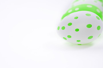 Easter eggs colored  green white decorated on white paper background. Happy Easter card with copy space for text. Minimal eco easter style.