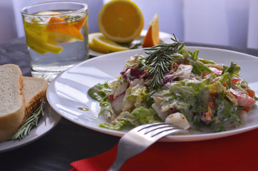 Salad with radishes, lettuce and cherry tomatoes seasoned with diet yogurt. Vitamin spring salad of fresh vegetables. Top view and side view.