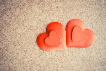 Two Red hearts on the wooden desk background.