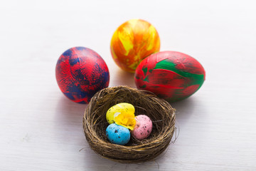 Holidays, traditions and Easter concept - Multi-colored decorative colourful eggs on white background.