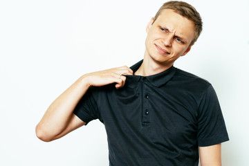 Closeup portrait of young man opening shirt to vent,it's hot. Negative emotion, facial expression,...