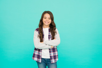 Living happy life. Good mood concept. Positive vibes. Sincere emotions. Cute girl with long hair. Small girl checkered shirt. Happy international childrens day. Little girl turquoise background