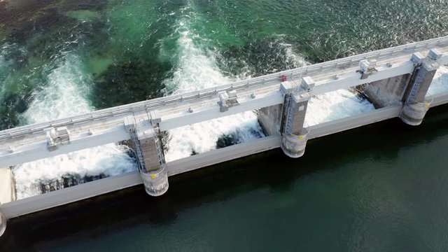 Dam with flowing water at hydroelectric power station located south of Lake Como.