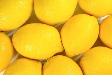 Ripe yellow lemons close-up. Lemon background, top view.