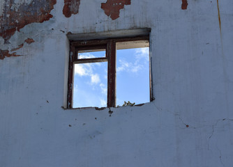 Demolish a house. The destruction of the walls. Dismantling the building. Window on the old wall.