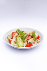 white deep plates with fresh salad ingredients mixed with sauce placed on isolated white background. A place for a menu, banner or advertisement