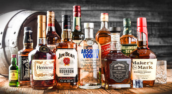 VAVRISOVO, SLOVAKIA - SEPTEMBER 14, 2019: Famous whiskey bottles and whisky barrel, The most popular liquor in the world. Alcohol drink wide banner or panorama concept.