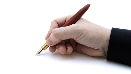 Holding fountain pen in hand front view with black shirt on white background with narrow focus