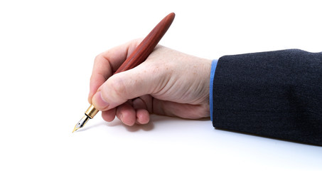 Holding fountain pen in hand top view signing document concept on white background with narrow focus