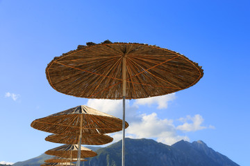 Fototapeta na wymiar Straw sun umbrellas