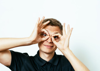 man looking through hands, making binoculars